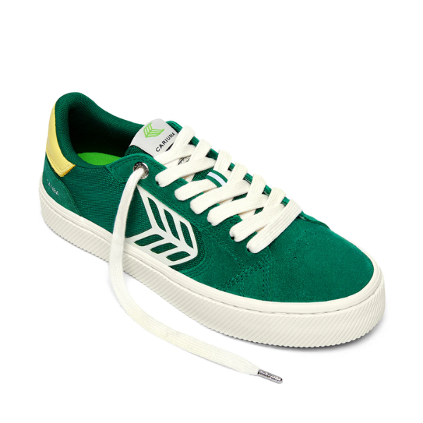 Green sneaker with white laces on a white background