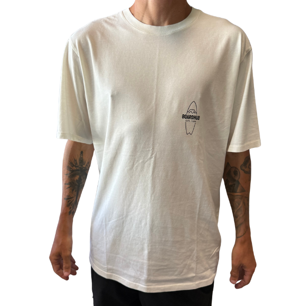 Person wearing a white t-shirt with a logo on a plain background